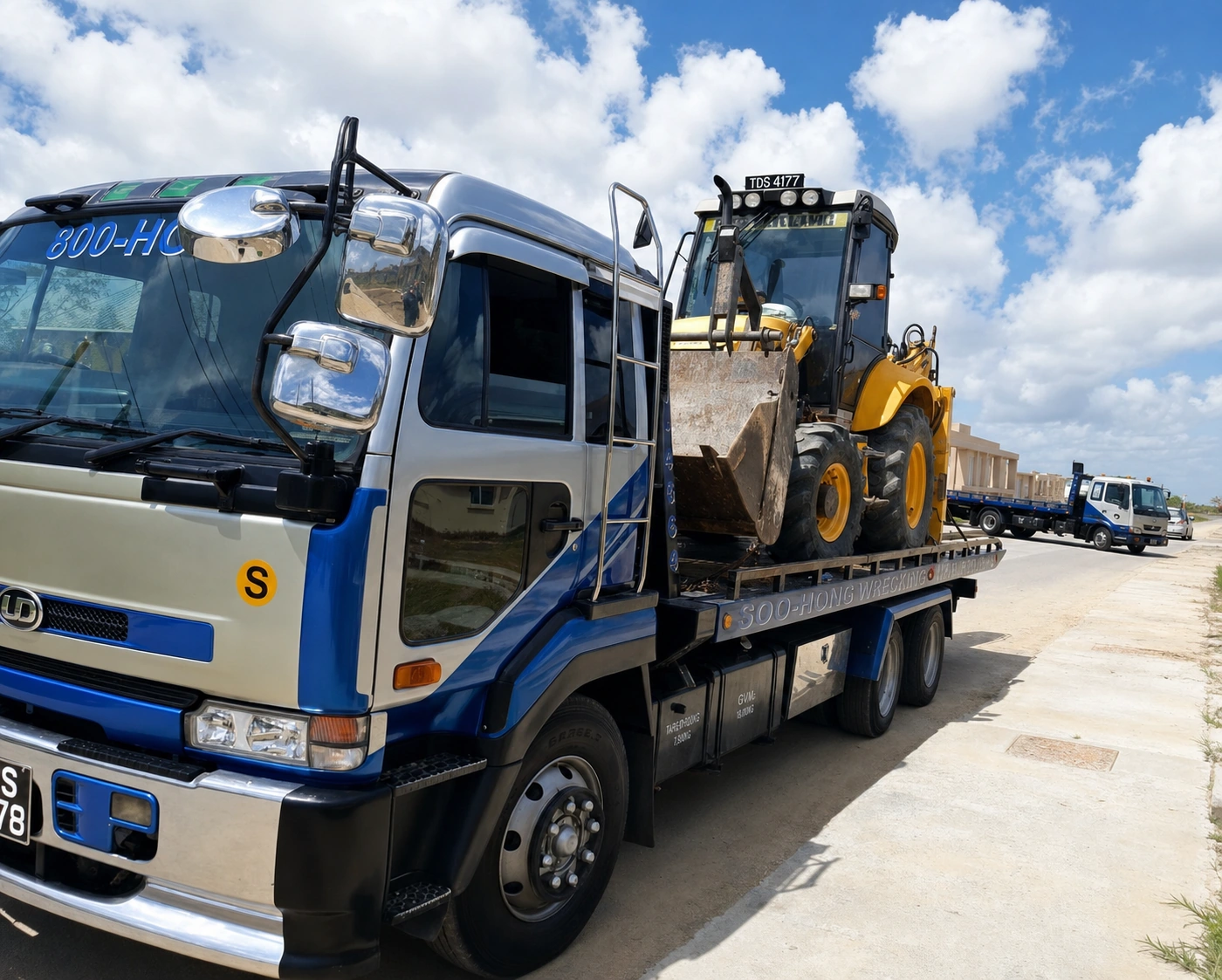 Soo-Hong recovery truck carrying heavy equipment in Trinidad and Tobago
